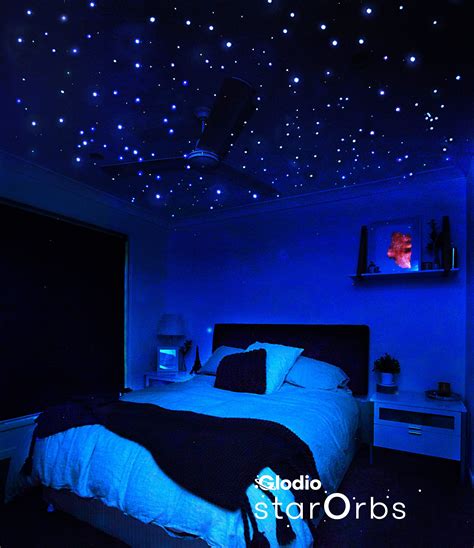 glow in the dark bedroom decor|blue ceiling with gold stars.